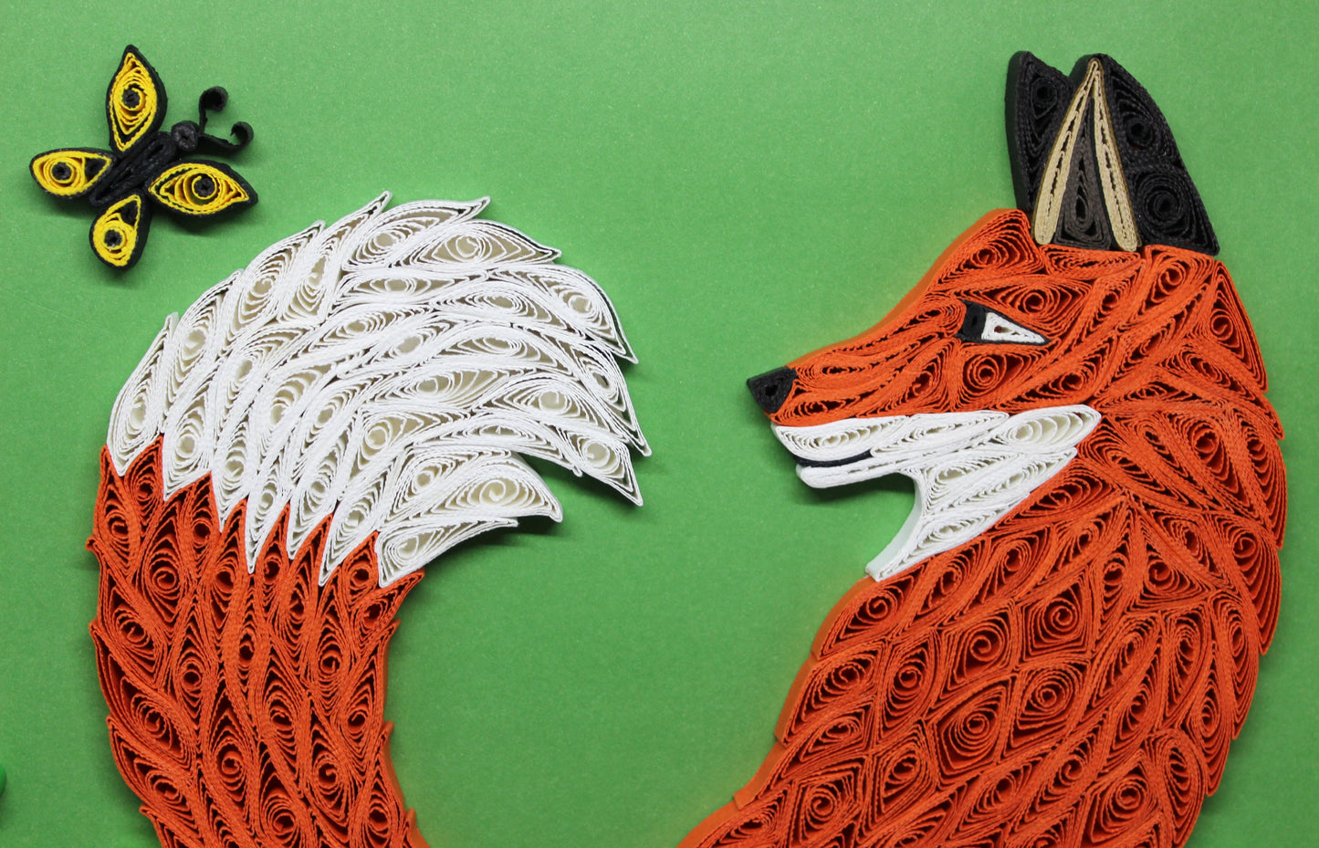 close up of quilled red fox face, tail, and butterfly
