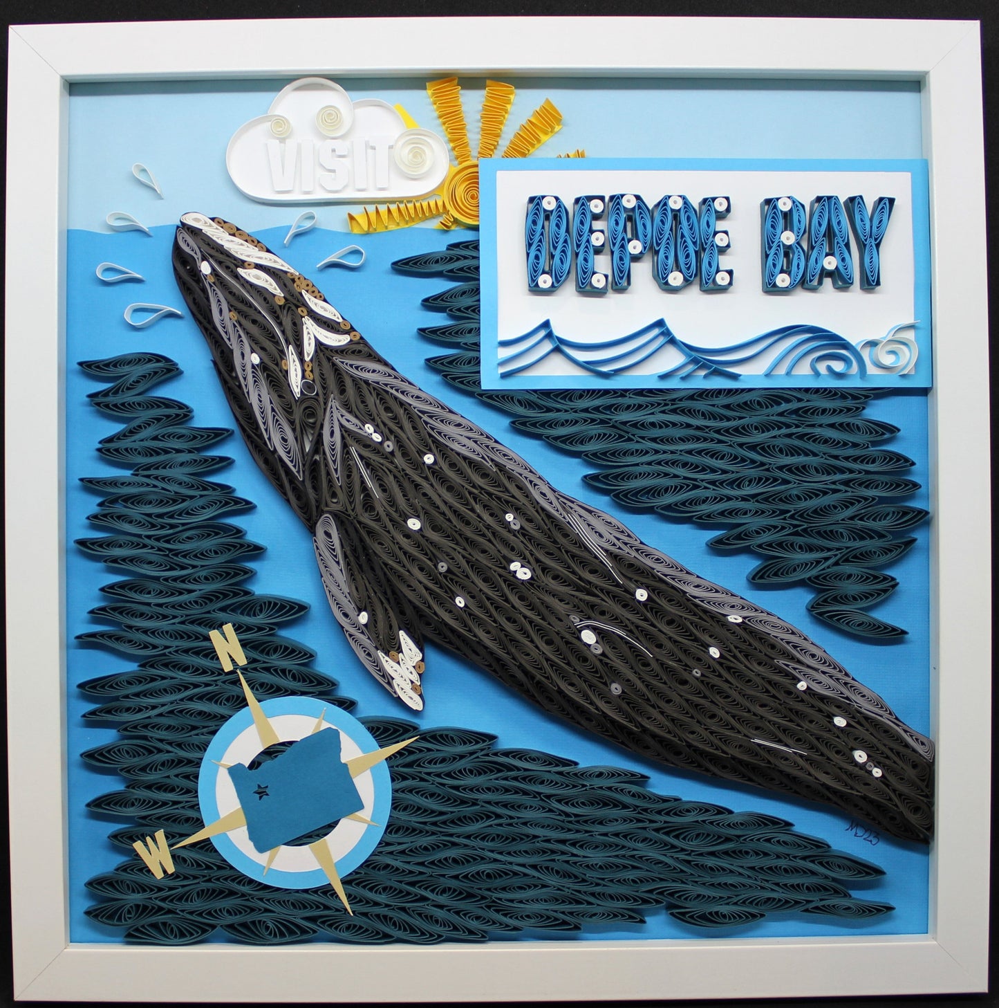 a quilled gray whale features prominently in this travel poster inspired design with words "Visit Depoe Bay" and a paper cut compass rose with Oregon silhouette